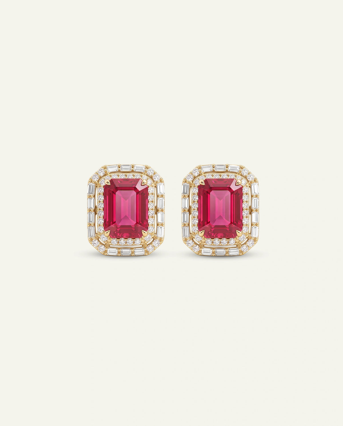 A pair of rectangular stud earrings featuring emerald-cut pink gemstones surrounded by a double halo of small clear stones in a yellow gold setting, presented on a light cream background.