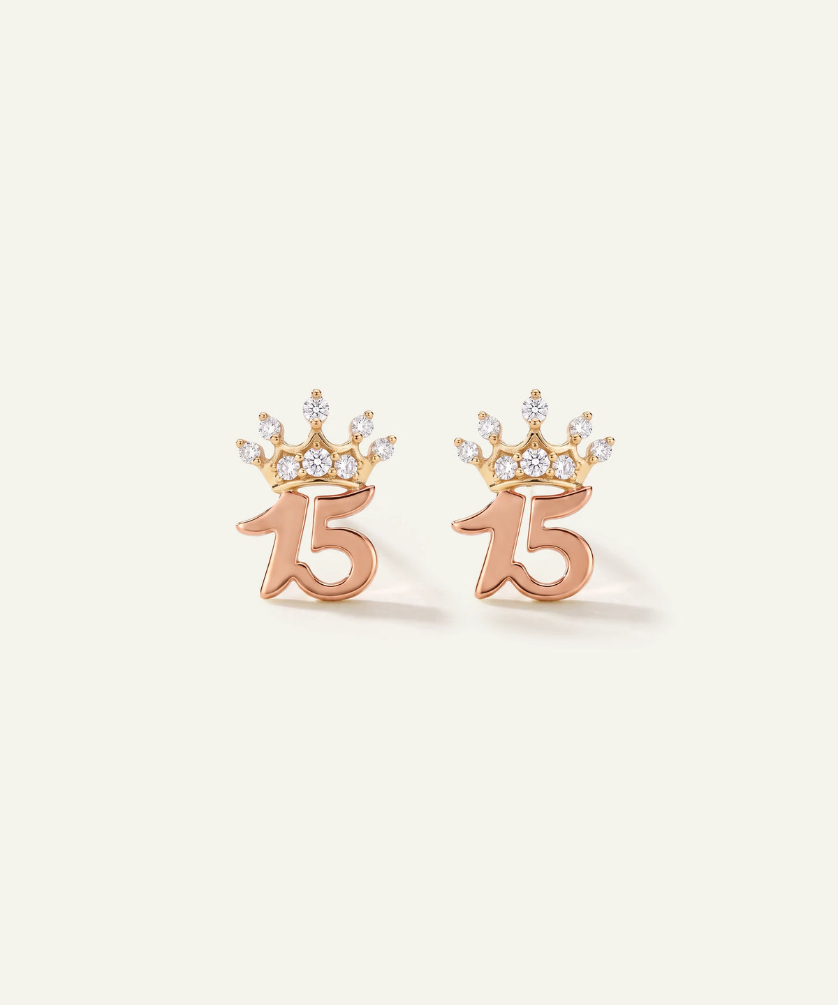 "Pair of rose gold '15' stud earrings topped with diamond-paved crown accents."