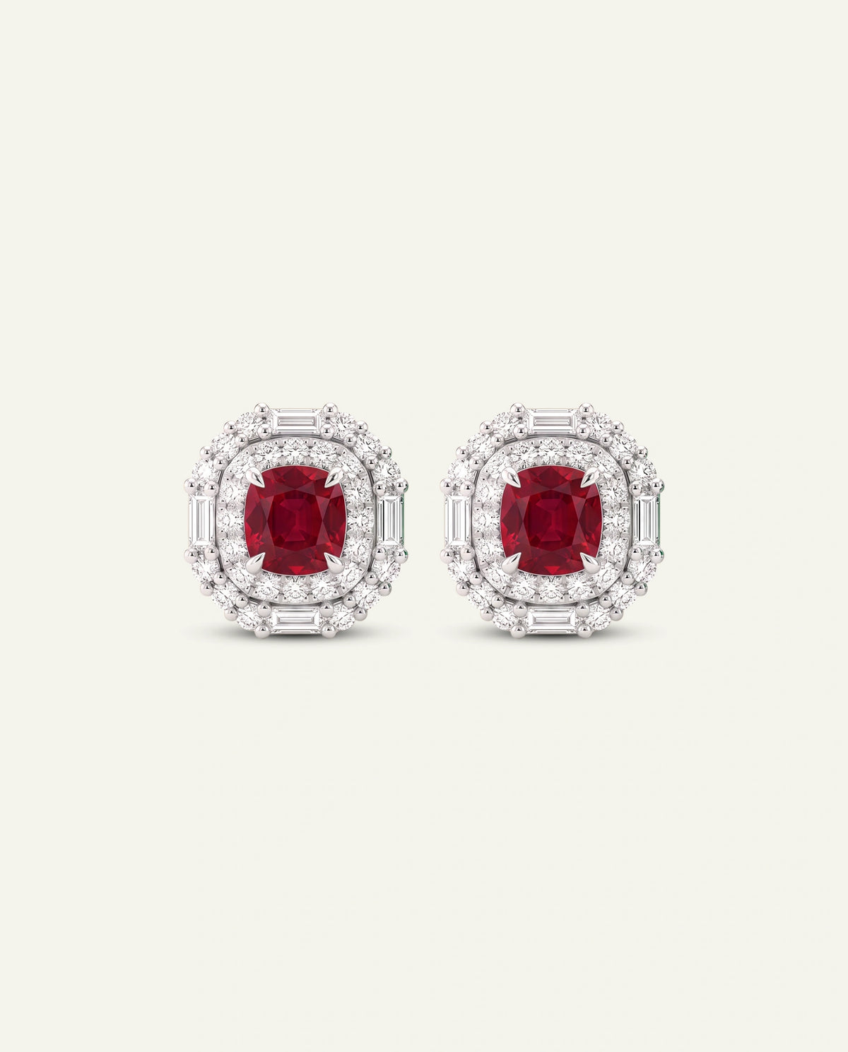 A pair of oval stud earrings featuring a central cushion-cut red ruby surrounded by a double halo of round and baguette-cut clear stones in a silver-toned setting, shown on a light cream background.