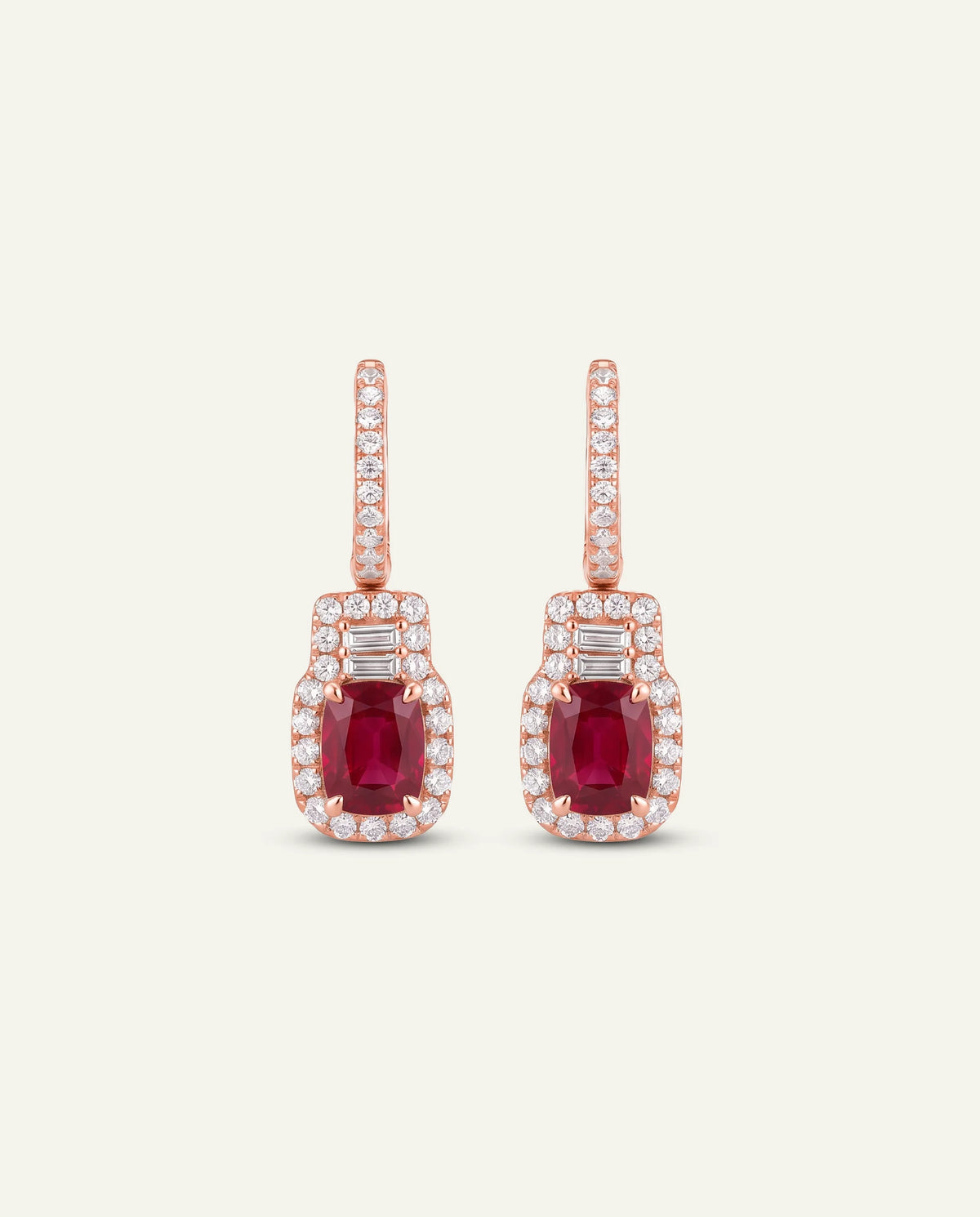 Gold earrings with purple gemstones on a white background