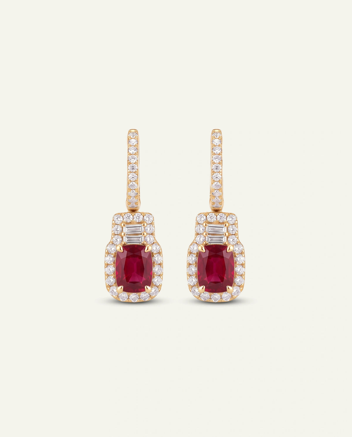 Gold earrings with purple gemstones on a white background