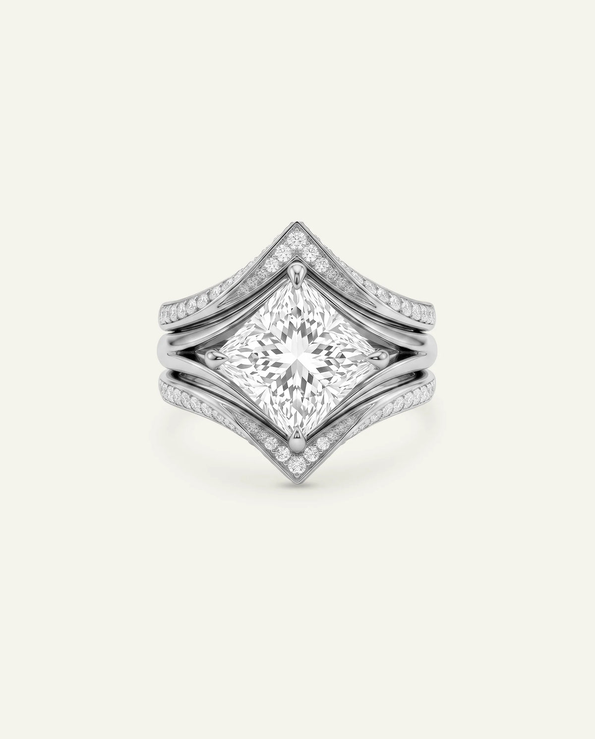 A silver-toned diamond ring featuring a large princess-cut center stone with a split shank design accented by pavé diamonds, set against a plain off-white background.