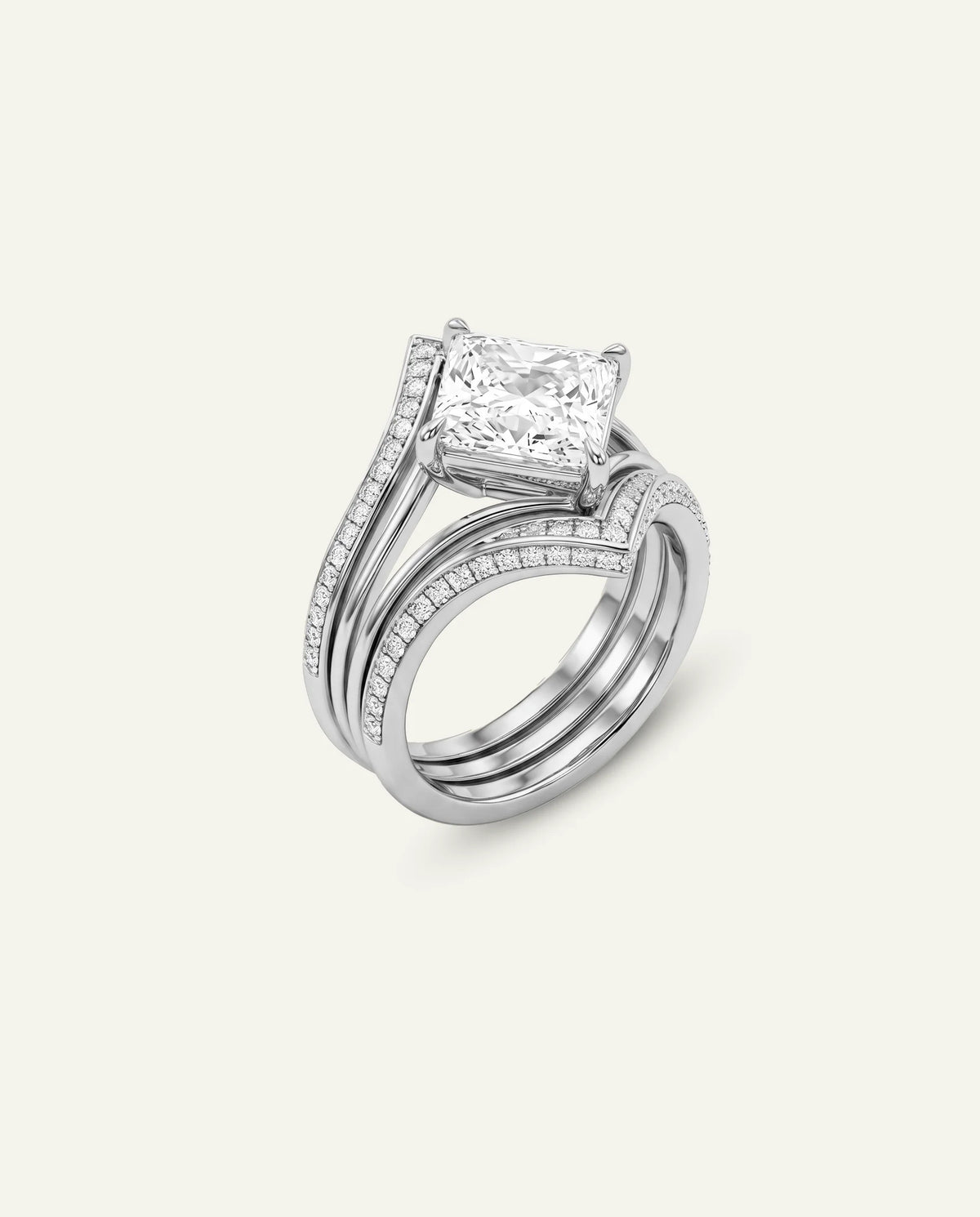 A silver-toned engagement ring set featuring a princess-cut diamond center stone and a matching pavé band, shown on a light cream background.