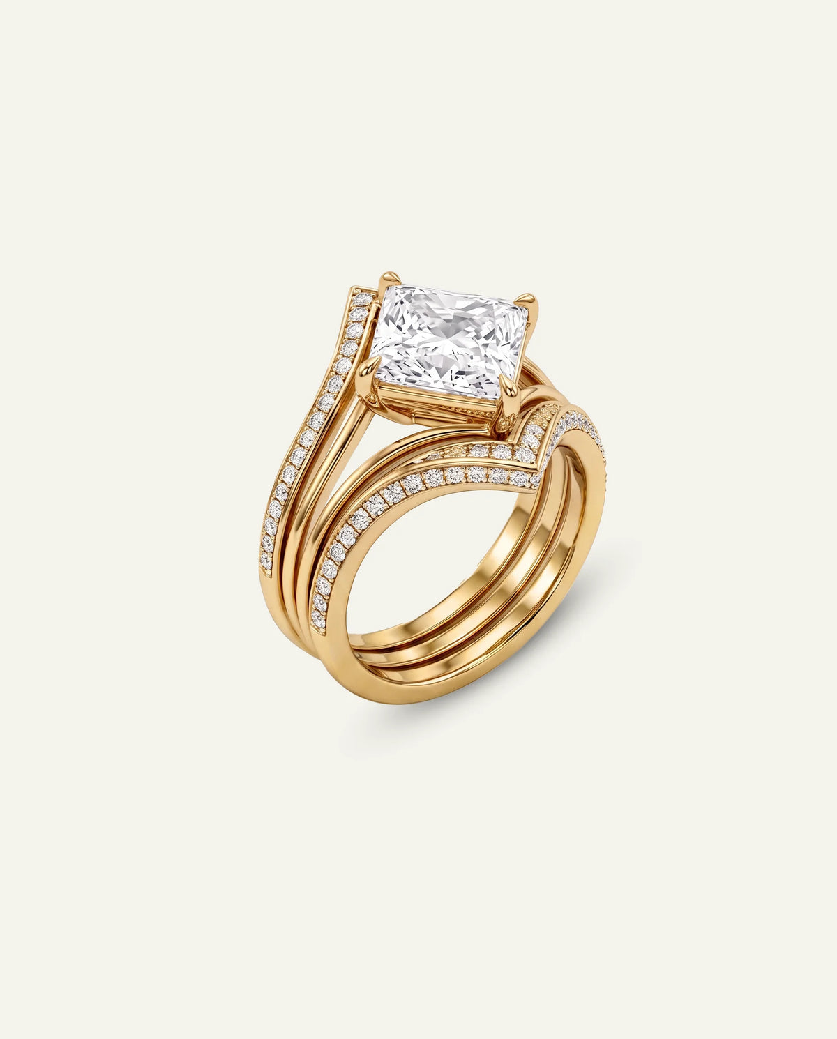 A yellow gold ring set featuring a princess-cut diamond engagement ring with a matching curved band adorned with pavé diamonds, shown on a light cream background.