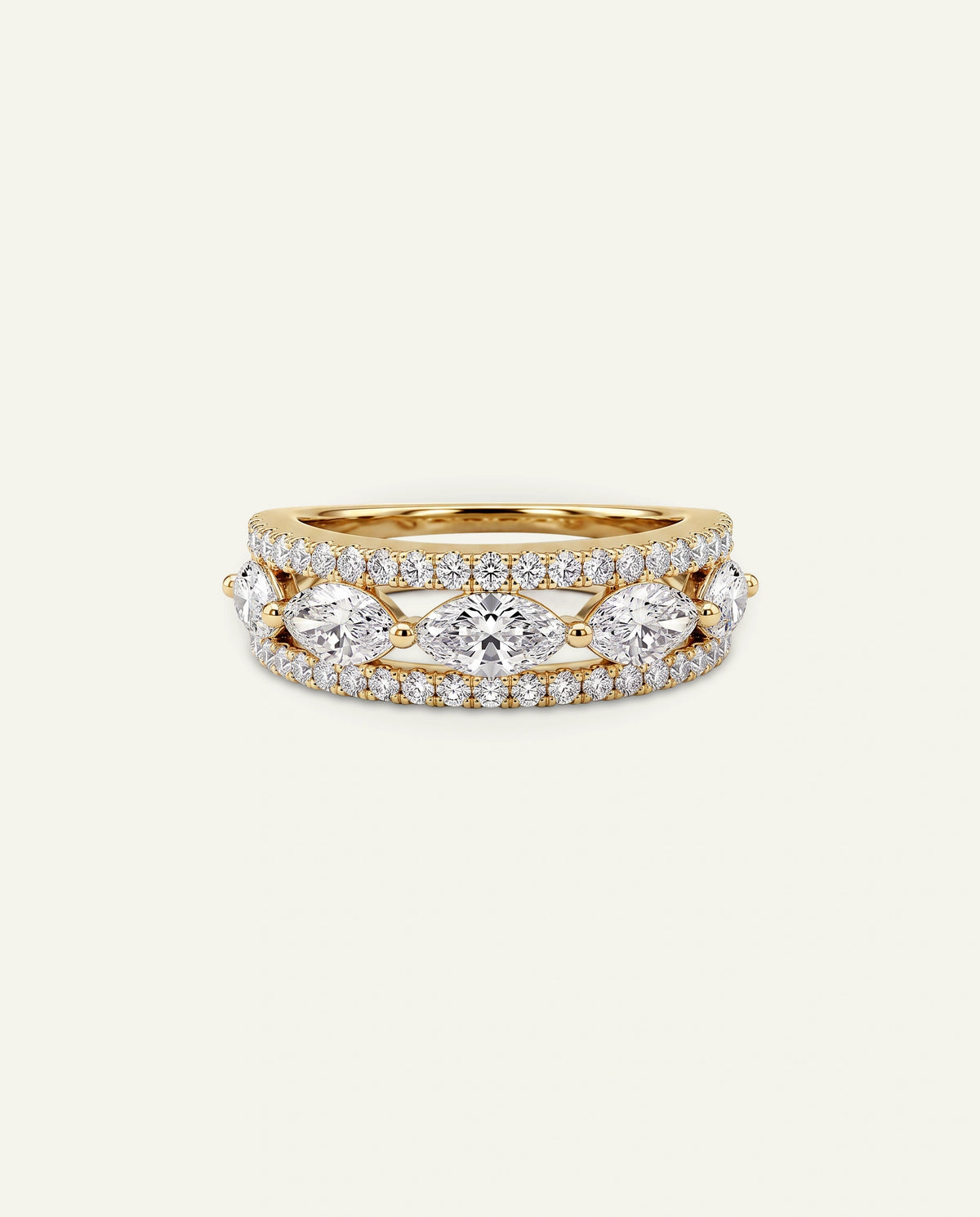 A gold ring featuring marquise-cut diamonds and smaller round diamonds, photographed on a clean, light off-white background.