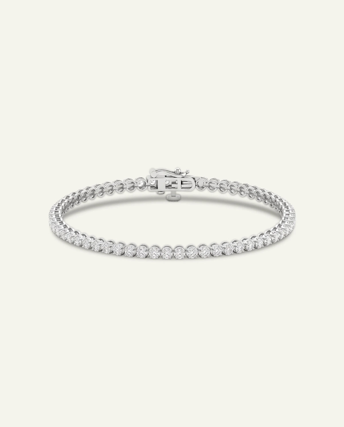 A silver tennis bracelet with a row of small clear stones and a clasp, shown on a plain light beige background.