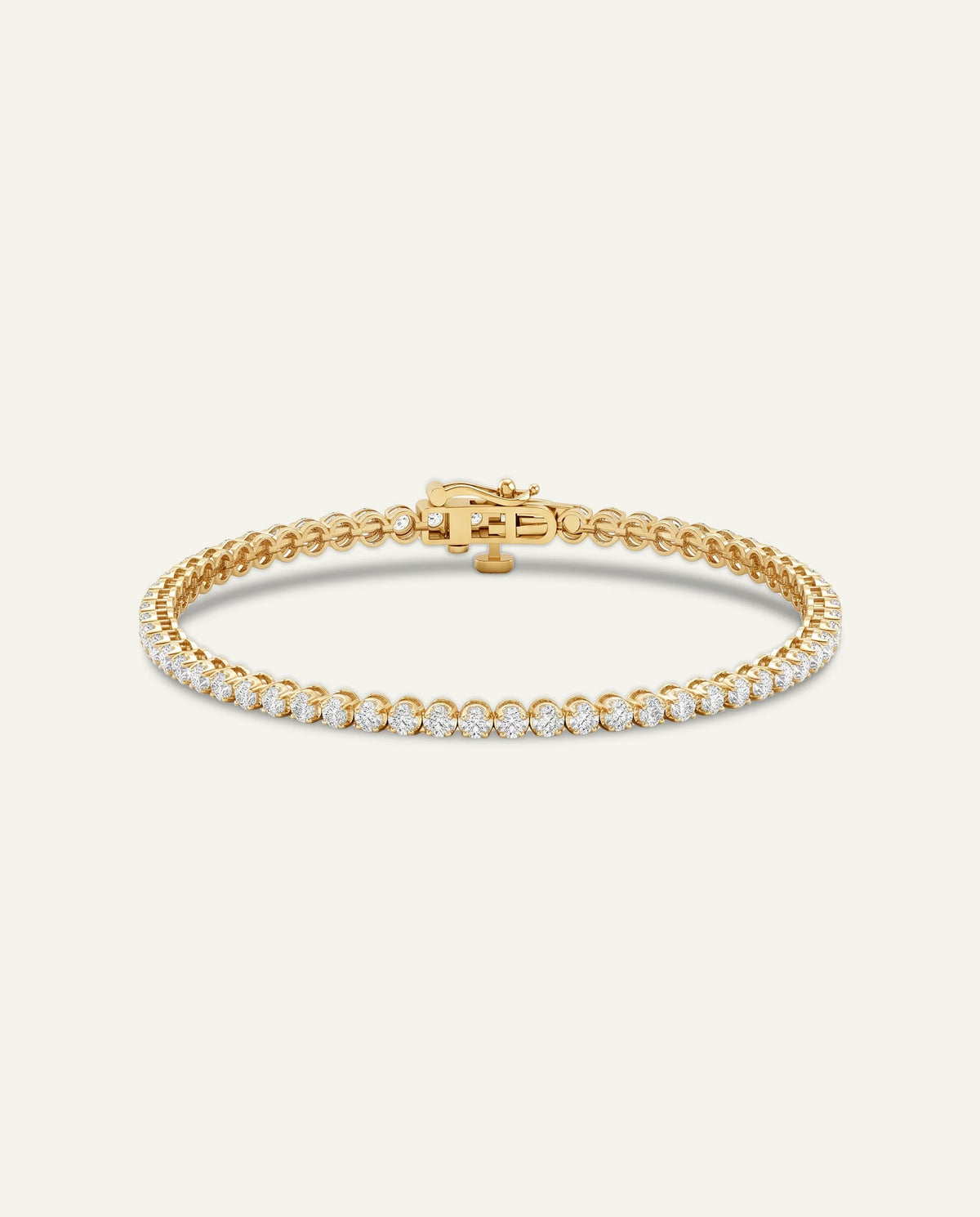 Yellow gold tennis bracelet set with round sparkling diamonds on a plain off-white background.