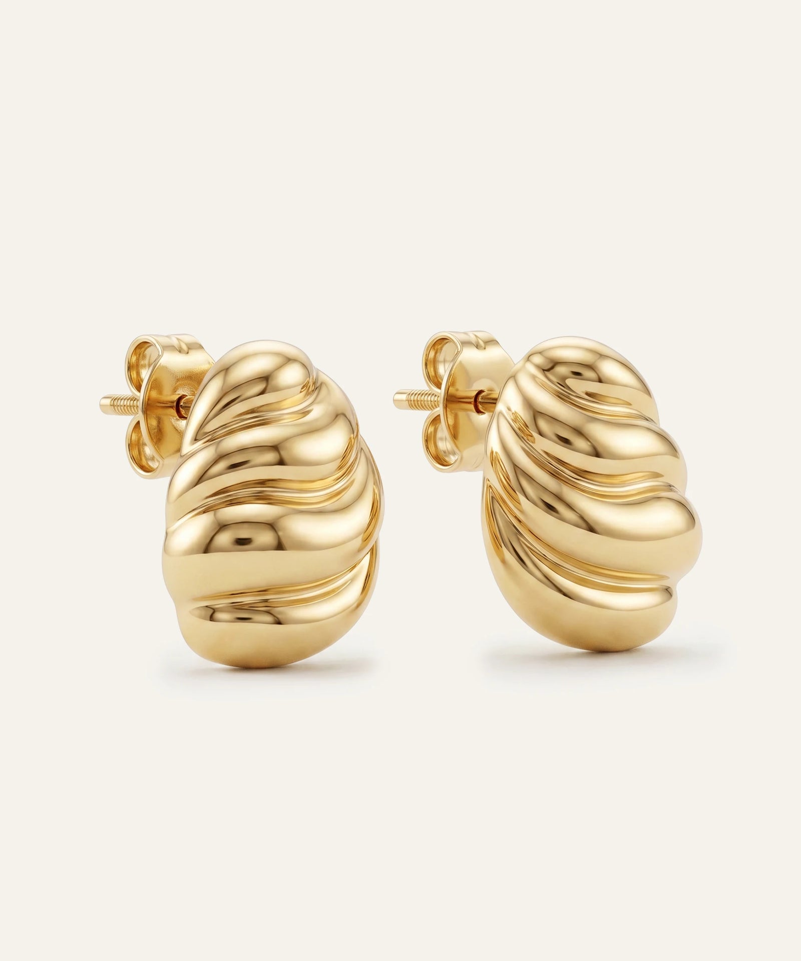 Pair of gold hoop earrings on a white background