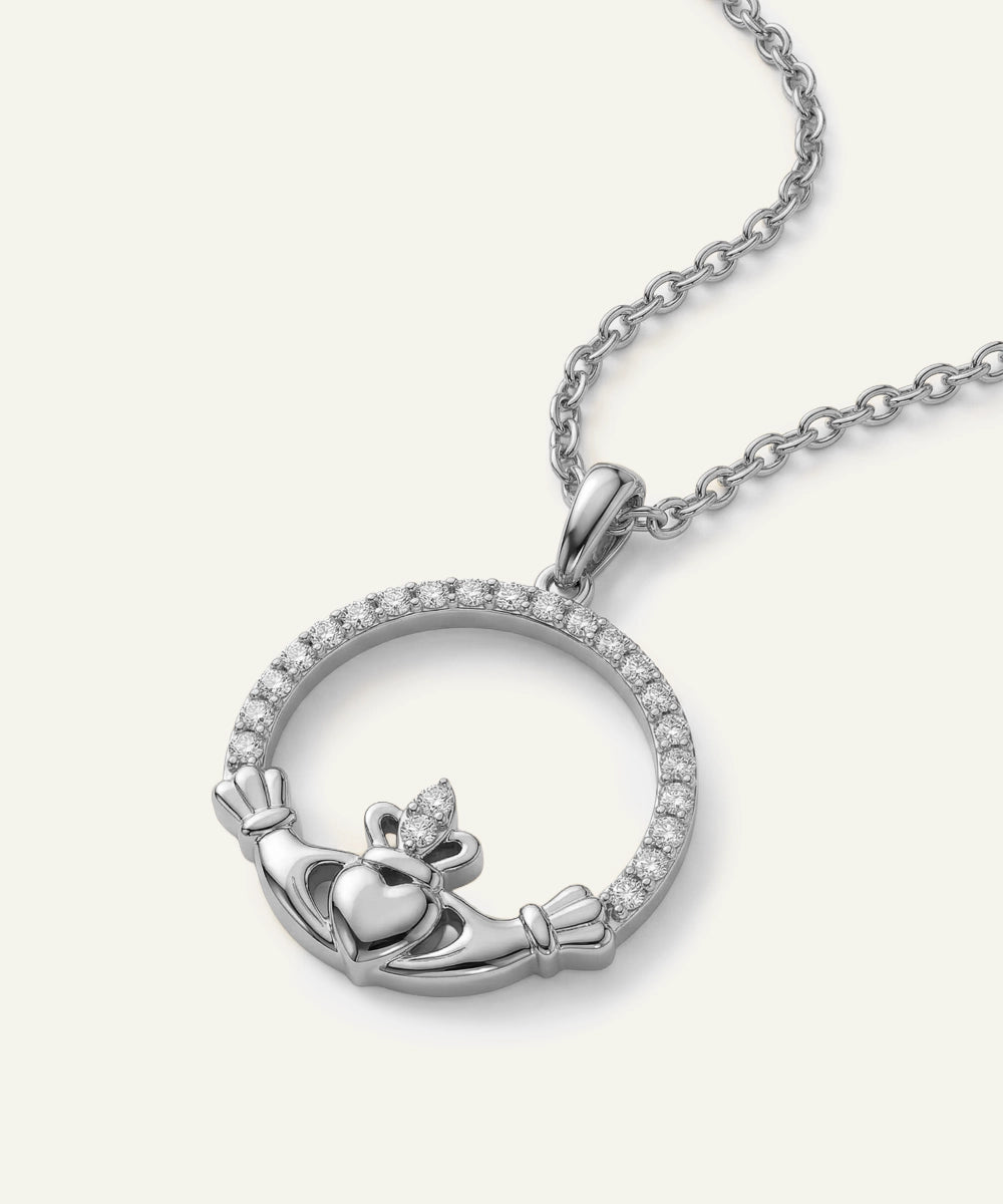 Silver Claddagh pendant necklace on a white background