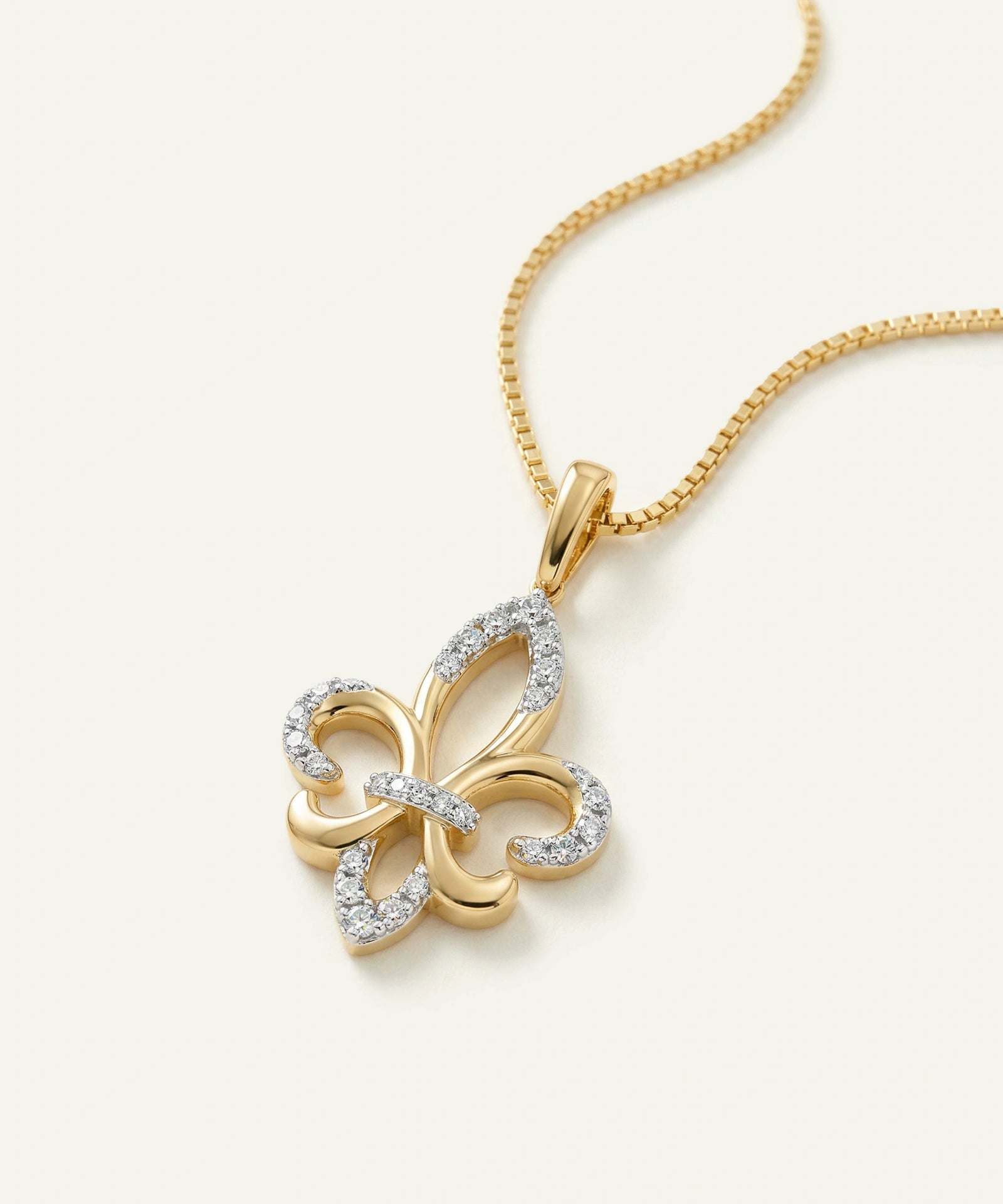 Gold butterfly pendant necklace on a white background
