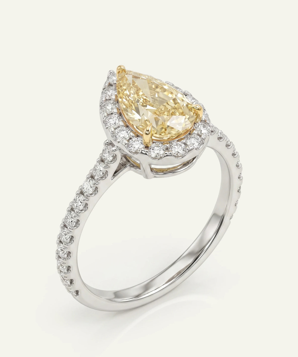 A white gold ring featuring a large pear-cut yellow diamond center stone with a halo of white diamonds and a pavé diamond band on a plain off-white background.