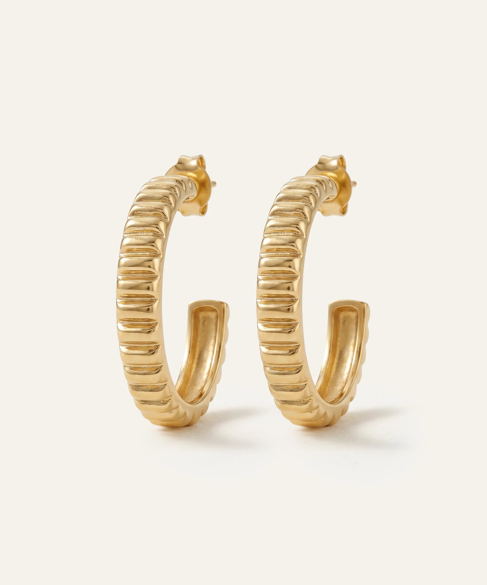 Gold hoop earrings on a white background