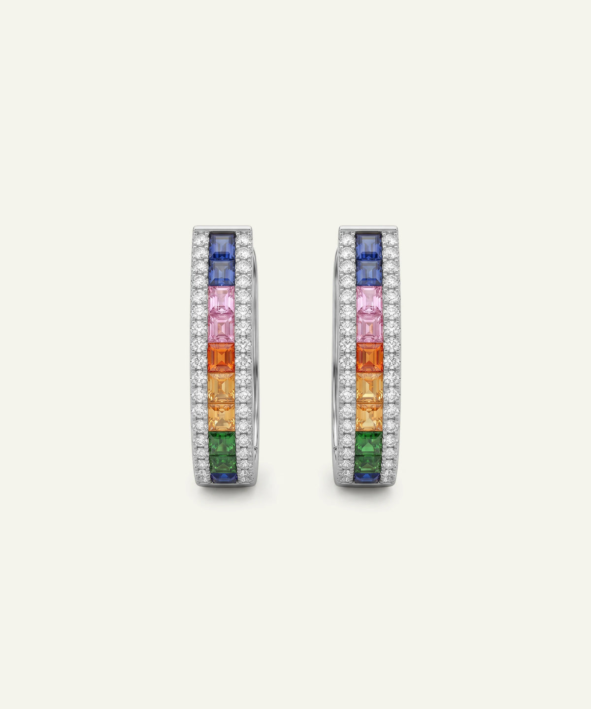 A pair of silver-toned hoop earrings featuring a vertical rainbow of baguette-cut gemstones (blue, pink, orange, yellow, green) surrounded by rows of small clear stones, set against a light cream background.