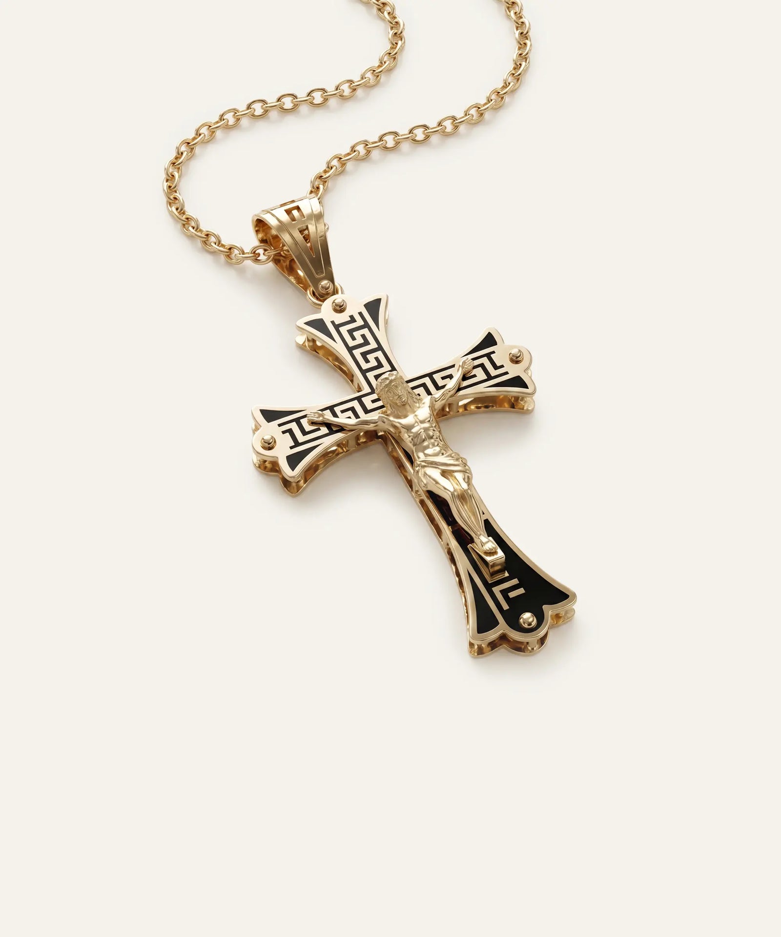 Gold cross pendant necklace on a white background