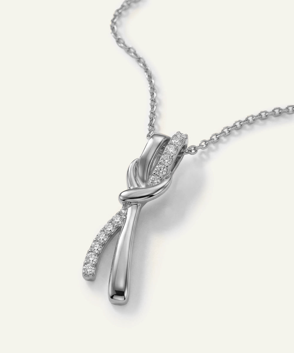 Silver necklace with a delicate pendant on a white background