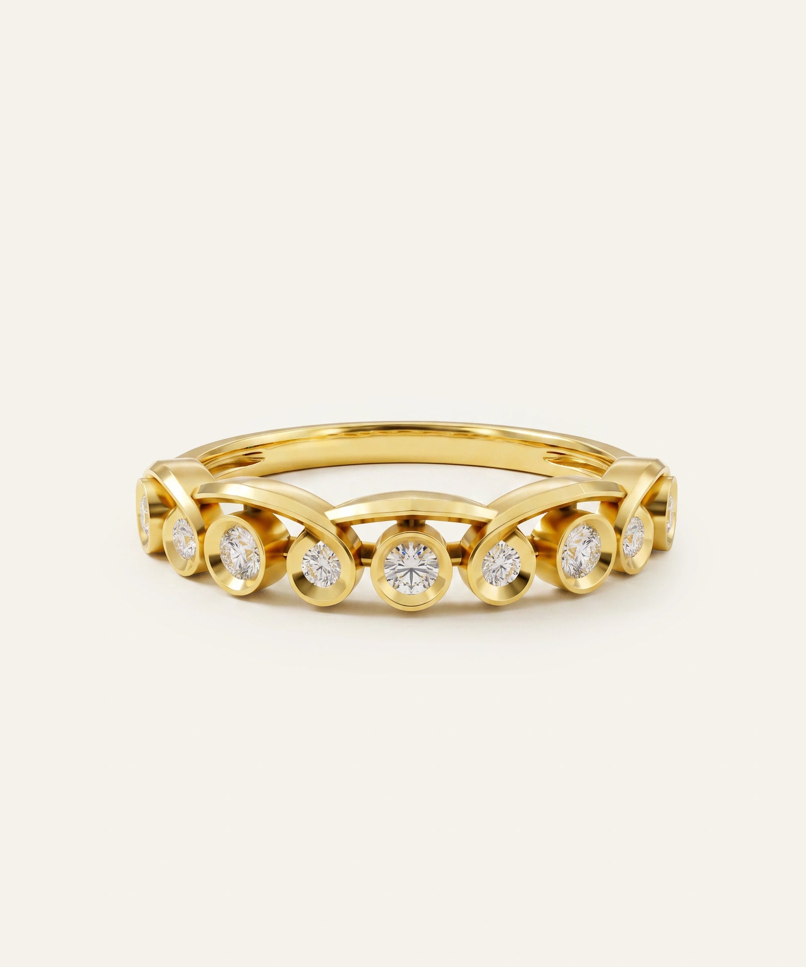 A yellow gold eternity ring featuring a row of round-cut clear gemstones in bezel settings, displayed on a clean off-white background.