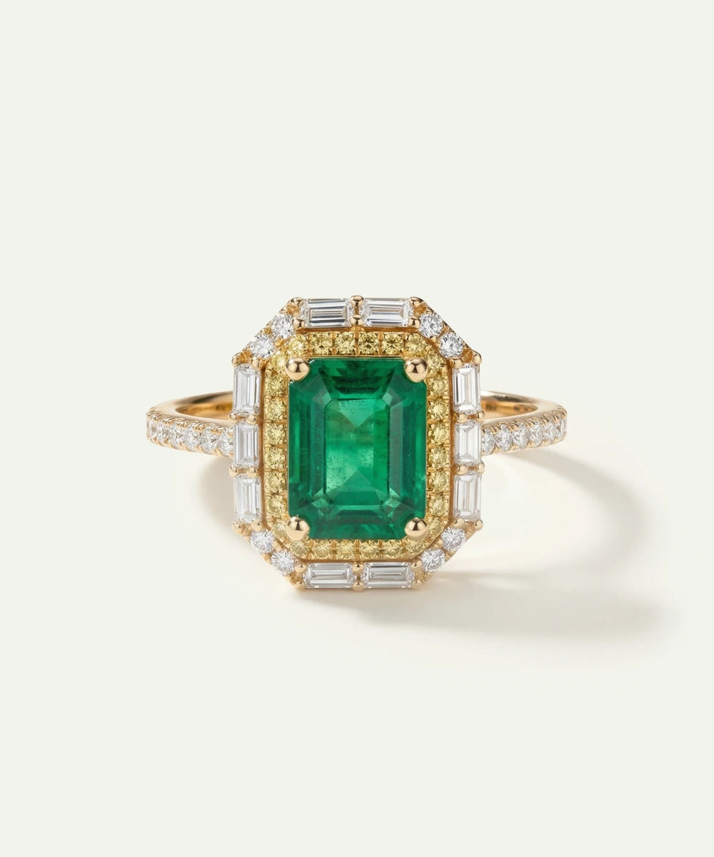 Gold ring with a green gemstone and diamond accents on a white background