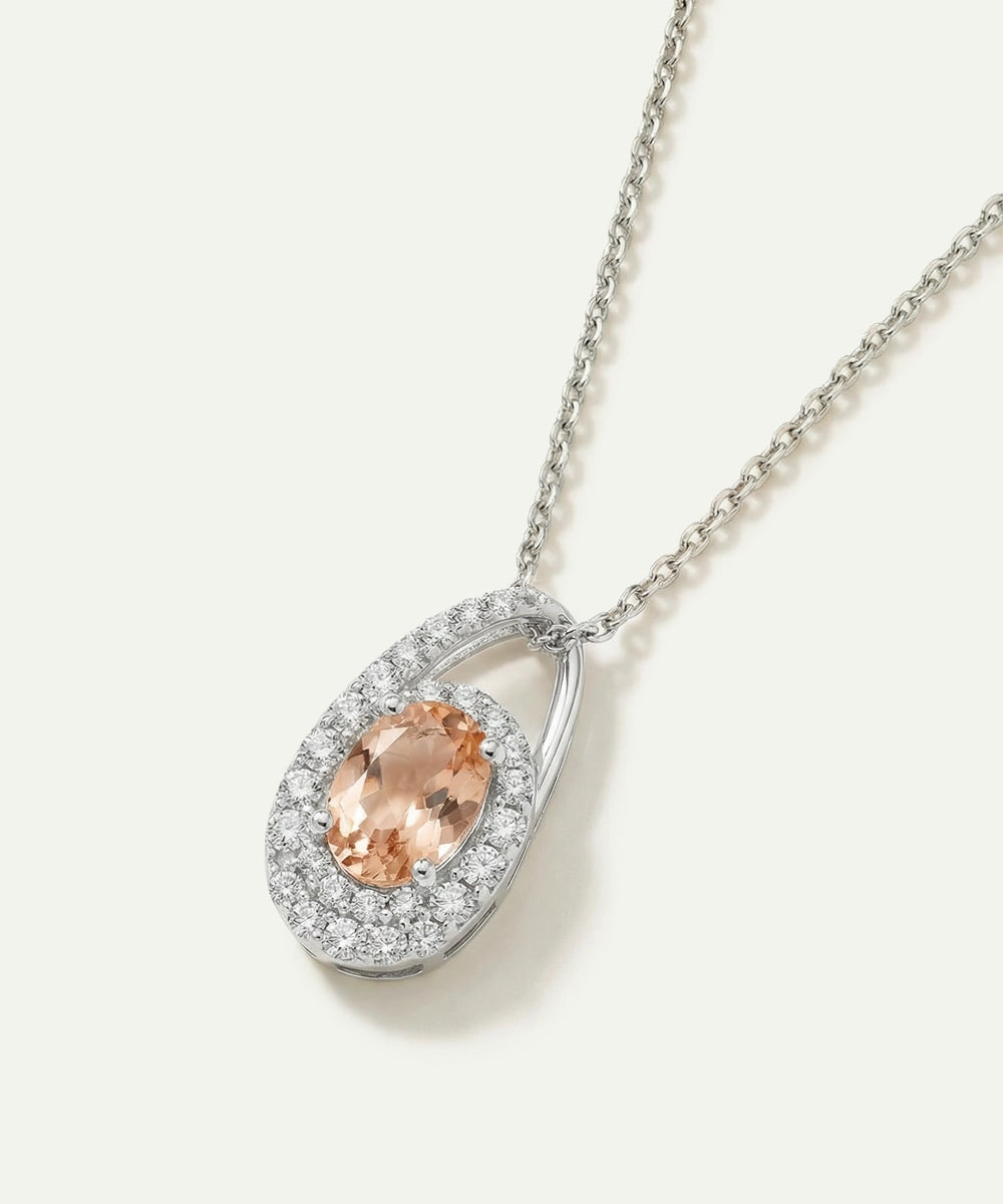 Silver necklace with a peach-colored gemstone pendant on a white background