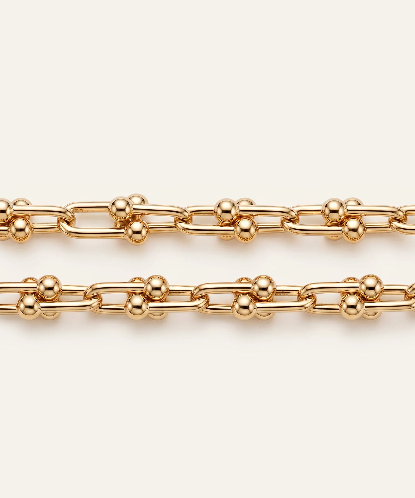 Gold chain on a light beige background