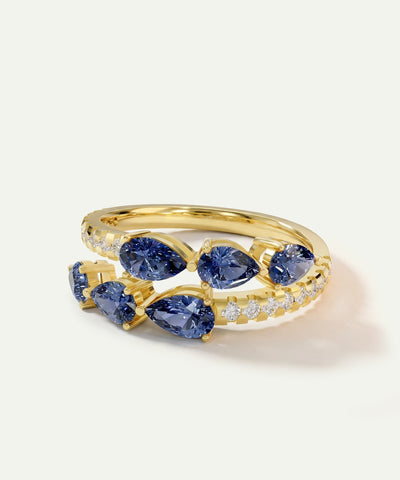Gold ring with blue gemstones on a white background