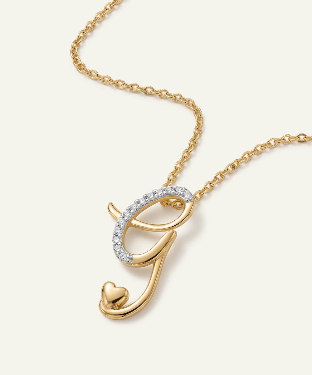 Gold necklace with a letter 'G' pendant on a white background