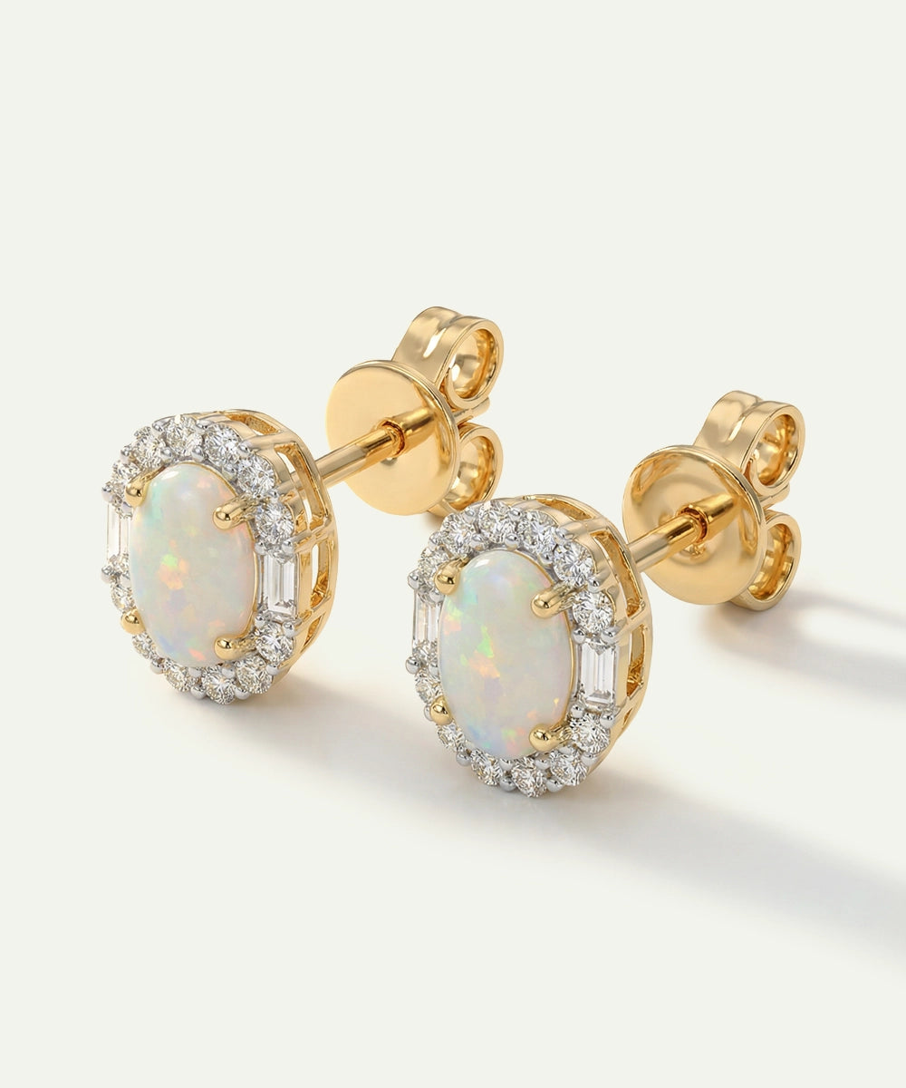 Gold earrings with opal stones on a white background