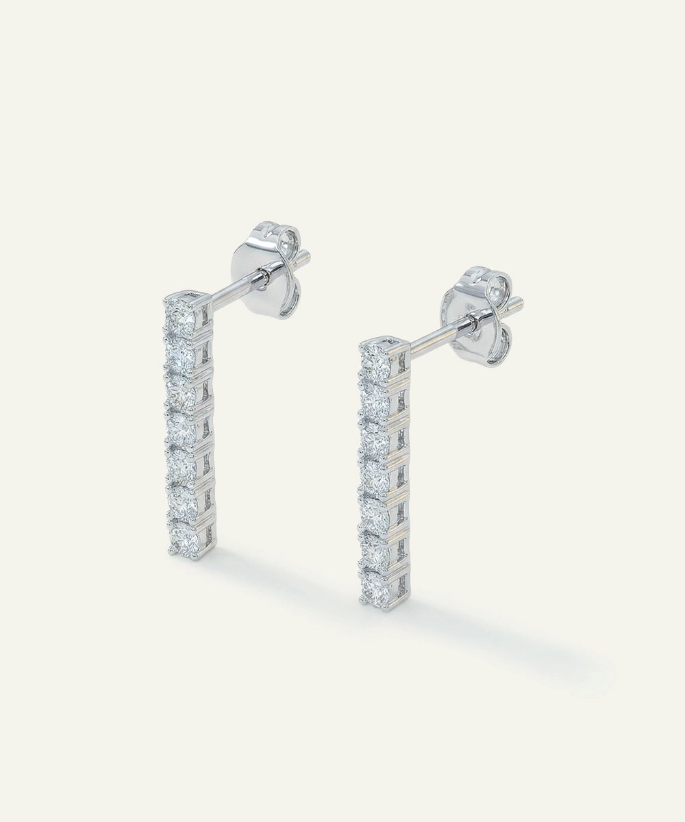 Pair of diamond stud earrings on a light gray background