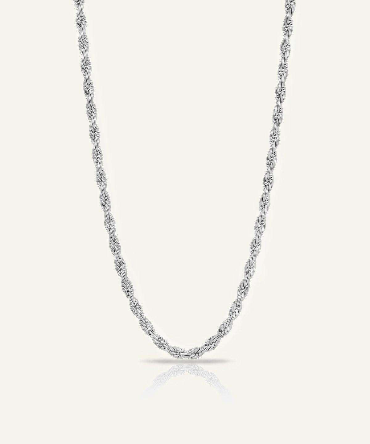A silver or white gold rope chain necklace displayed vertically against a light off-white background with a soft shadow at the bottom curve.