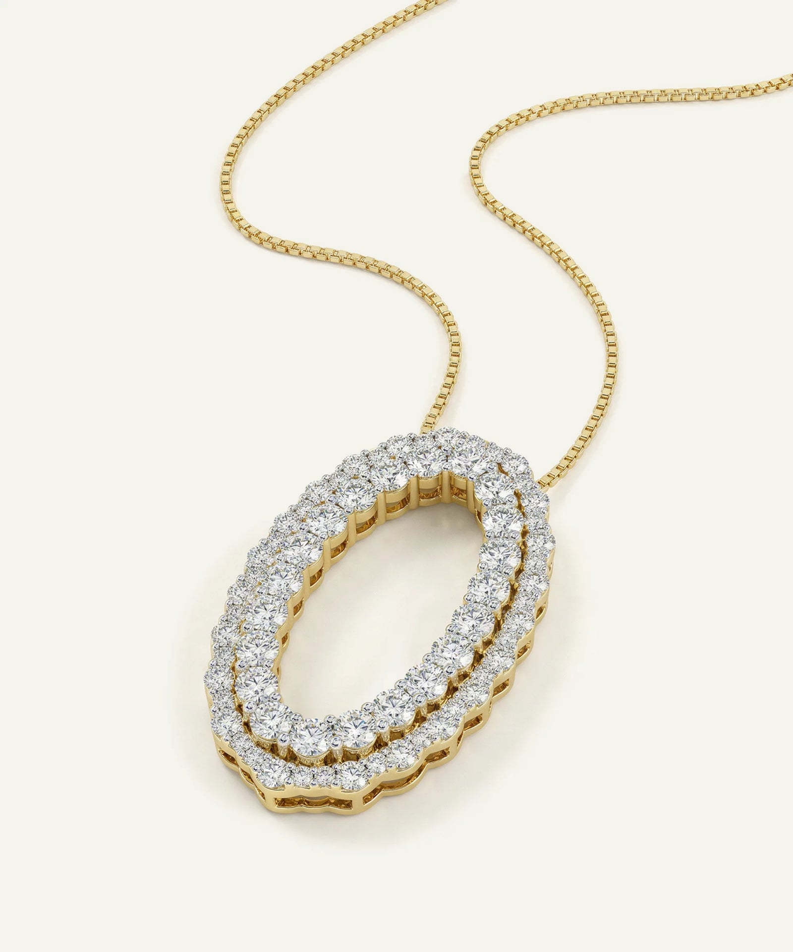 Gold necklace with a diamond pendant on a white background