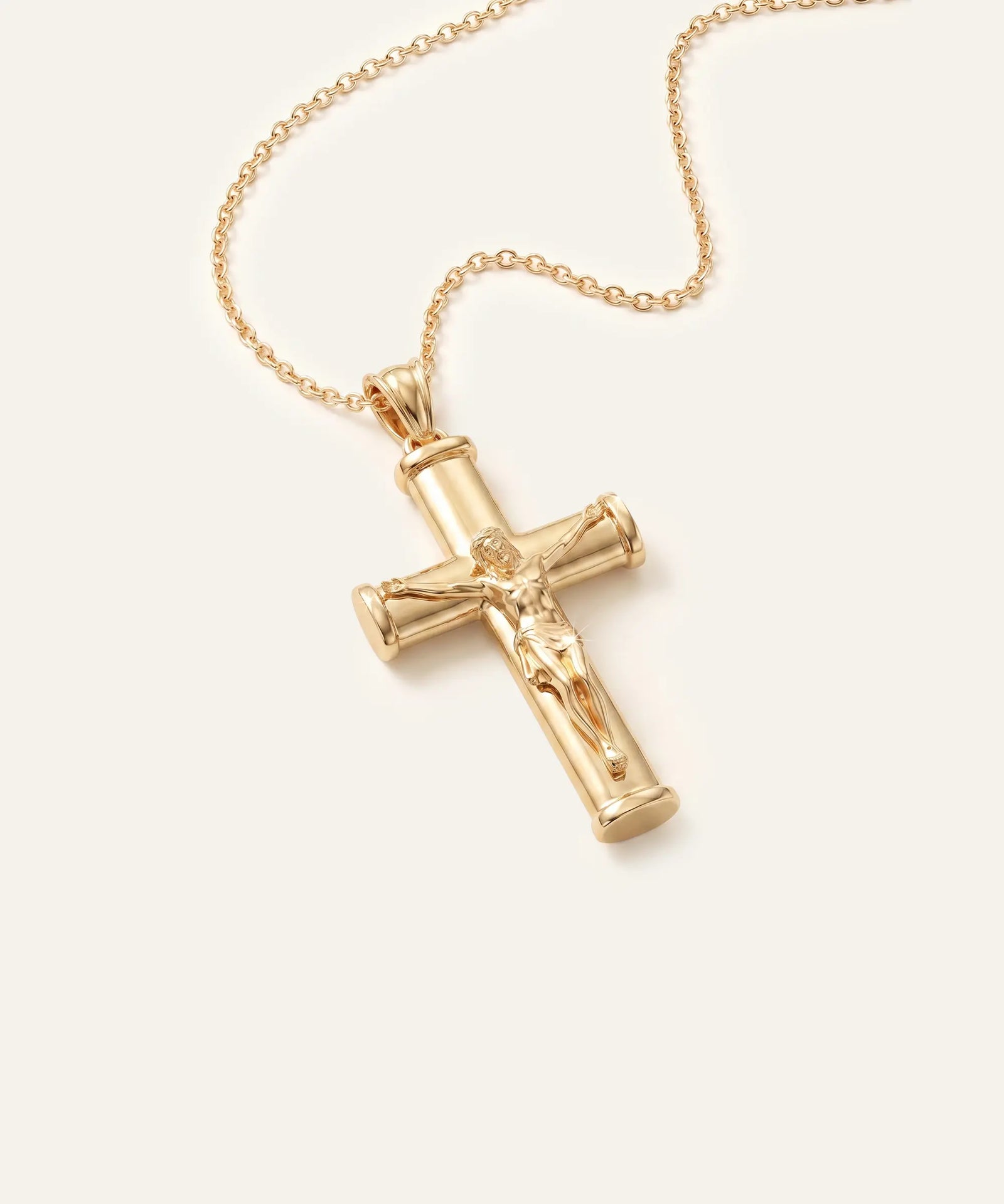 Gold cross pendant necklace on a white background