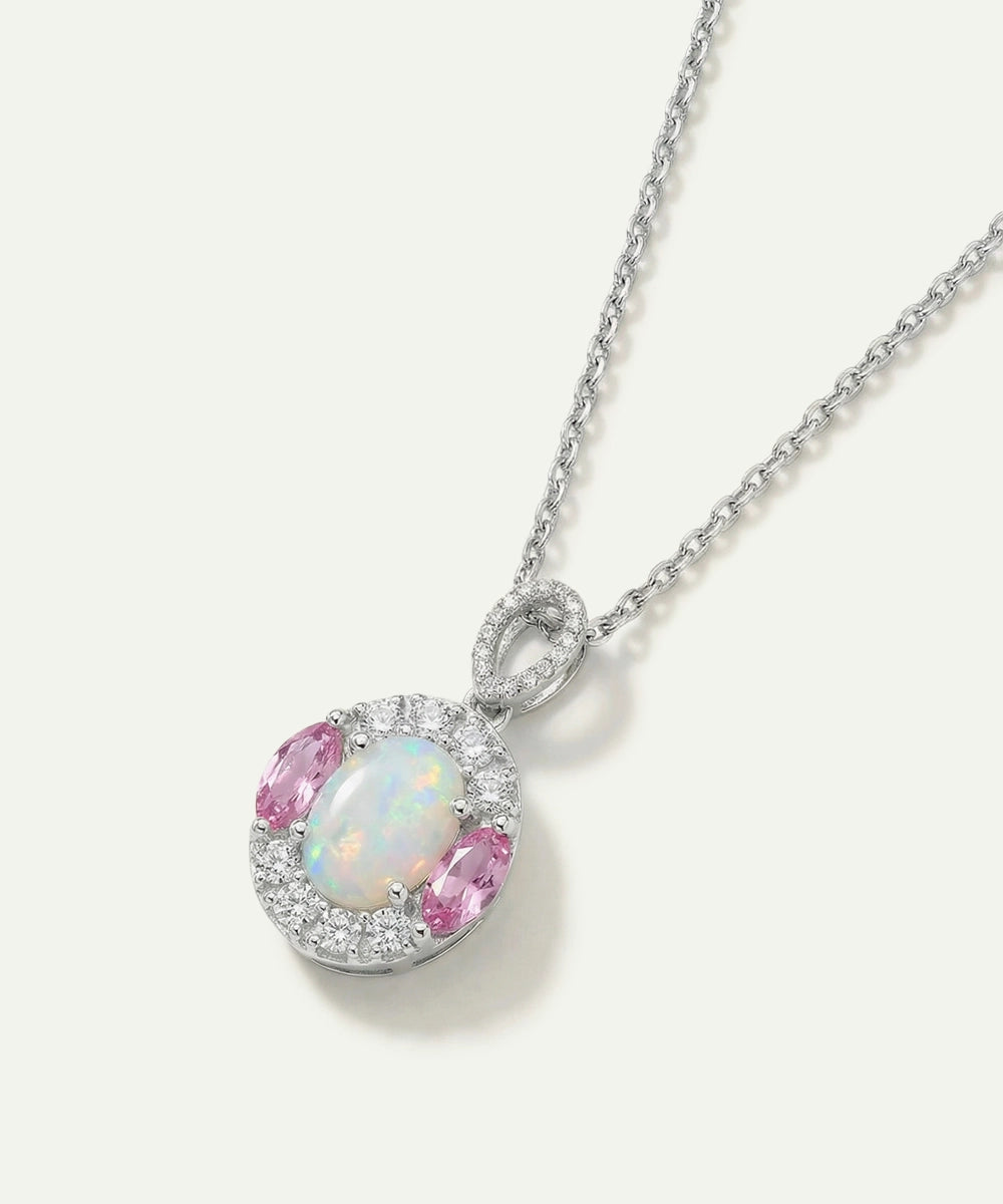 Necklace with a pendant featuring an opal and pink gemstone on a white background