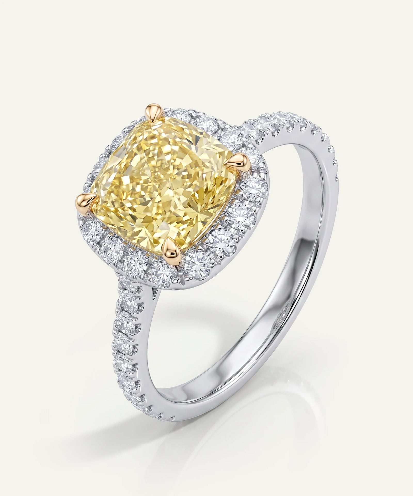 Ring with a yellow diamond and white gemstones on a light background