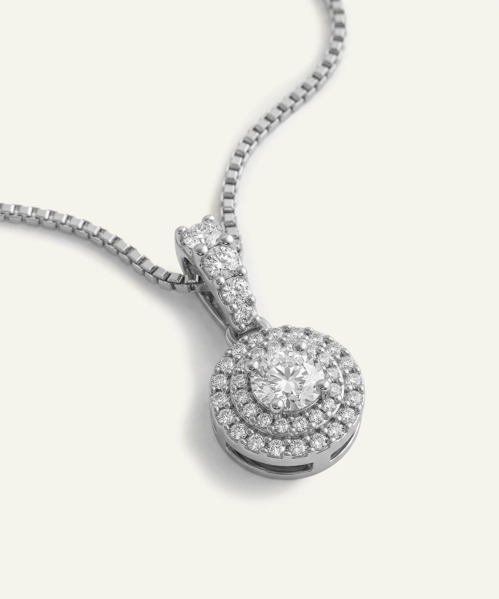 Diamond pendant necklace on a white background