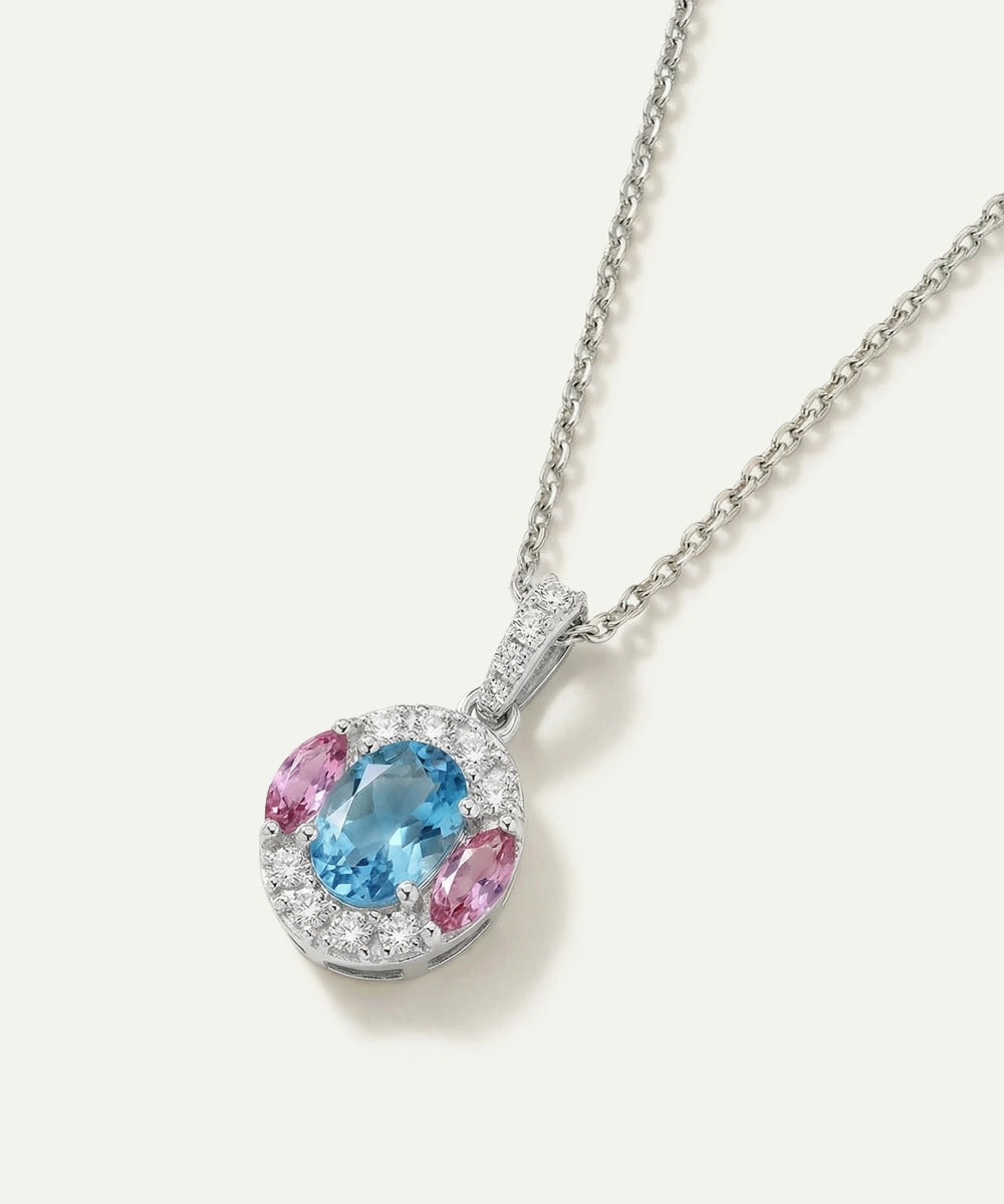 Necklace with a pendant featuring a blue gemstone and pink stones on a white background