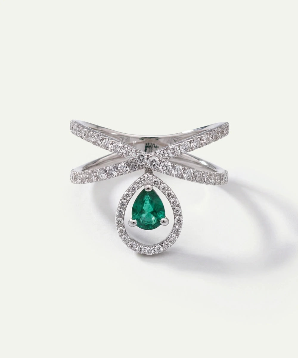 Silver ring with a green gemstone on a white background