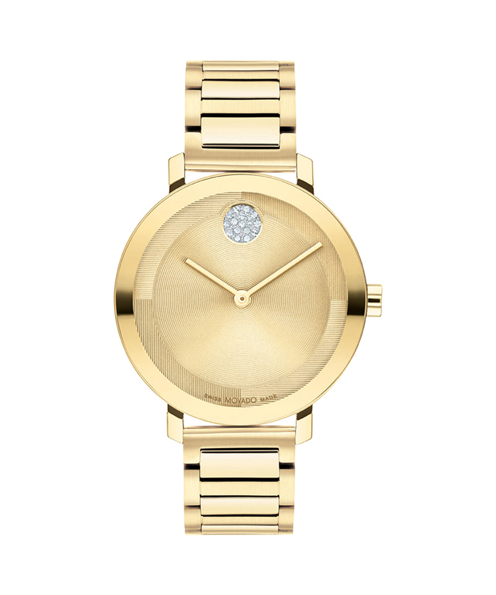 Gold watch with a diamond on the face against a white background