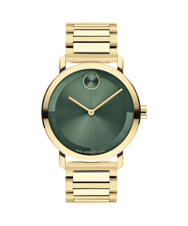 Gold watch with green face on a white background