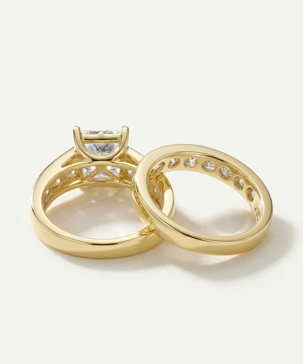 Inner setting and basket architecture view of a yellow gold princess-cut bridal ring set.