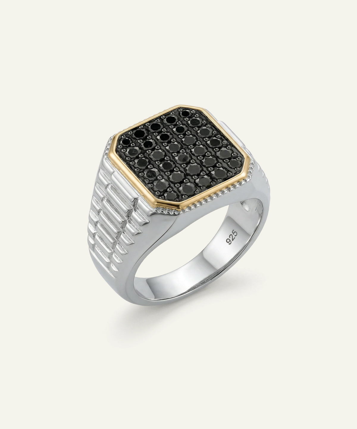 A men's signet ring featuring a silver-toned band with a textured channel-set side and a bezel-set top. The top is paved with small black round stones and framed by a gold-tone border, with a row of tiny clear stones along the front edge.