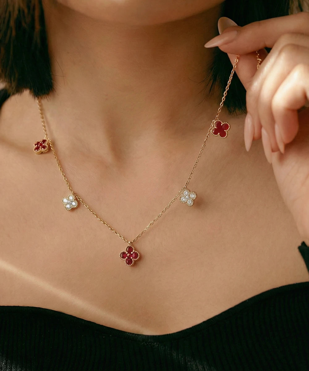 Necklace with floral pendants being adjusted by a hand