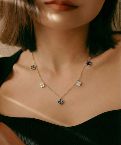Necklace with floral pendants worn by a person - alternate view
