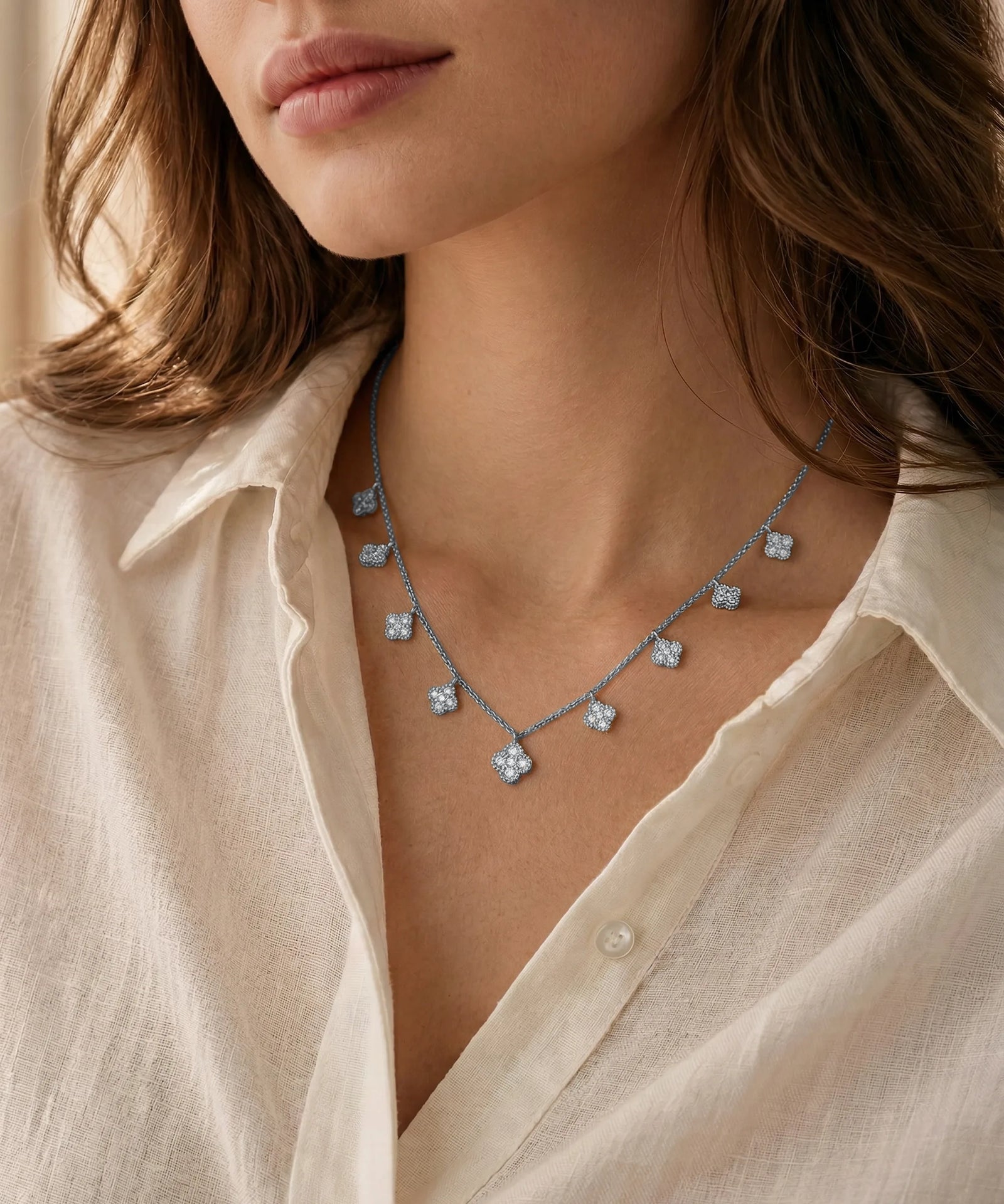 Necklace with blue stones worn by a person in a light-colored shirt