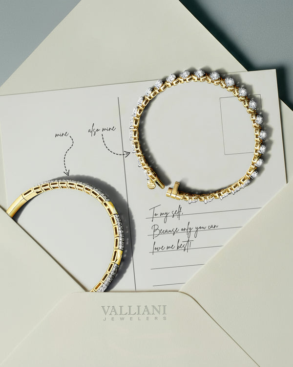 A gold and diamond tennis bracelet rests on an open envelope with a handwritten note, displaying Valliani Jewelers at the bottom. The bracelet casts a shadow on the cream-colored paper.