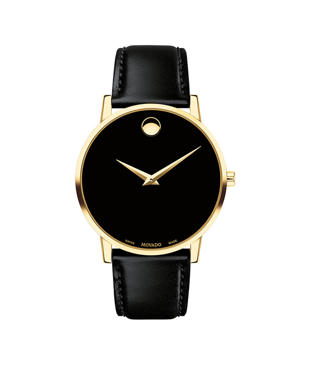 Black watch with gold bezel and black leather strap on a white background
