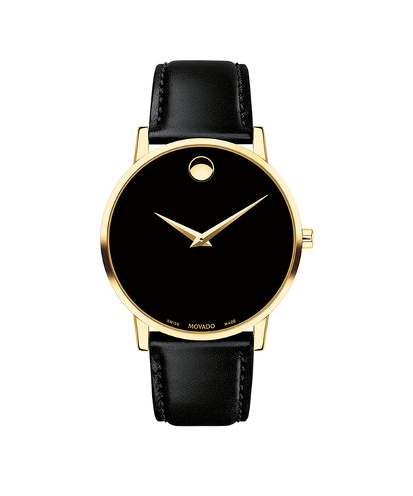 Black watch with gold bezel and black leather strap on a white background