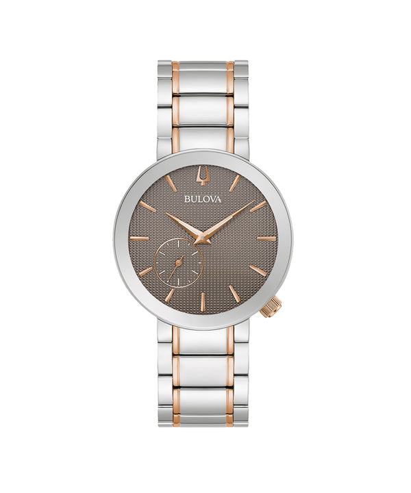 Bulova watch with silver and rose gold band on white background