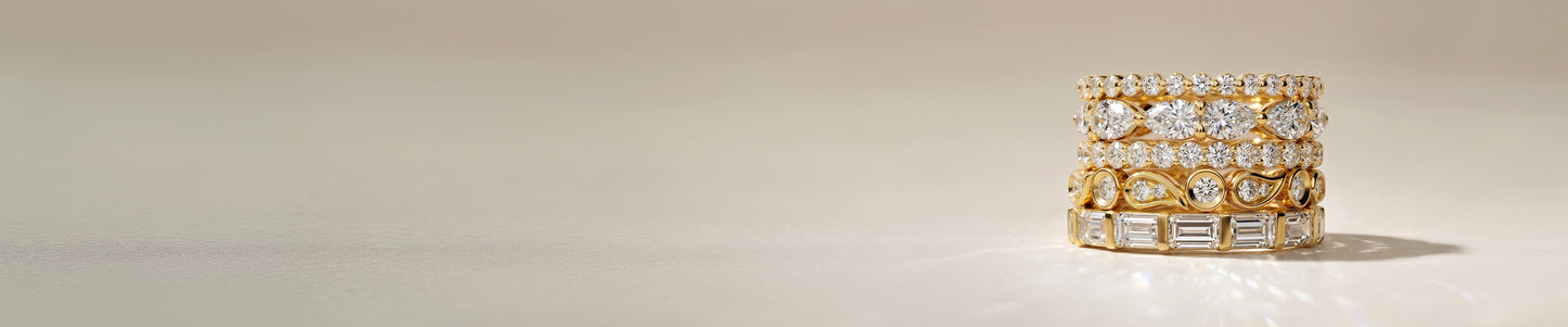 Gold ring with embedded diamonds on a light background