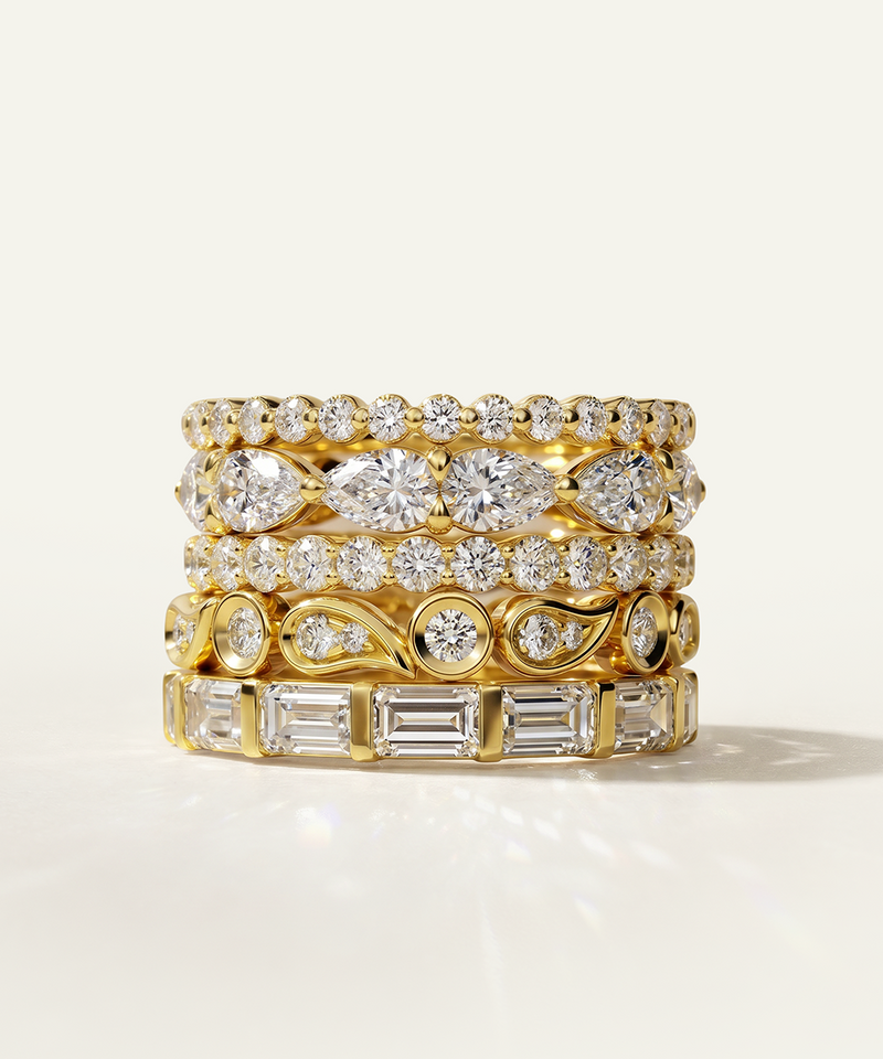 Set of gold and diamond rings on a light background