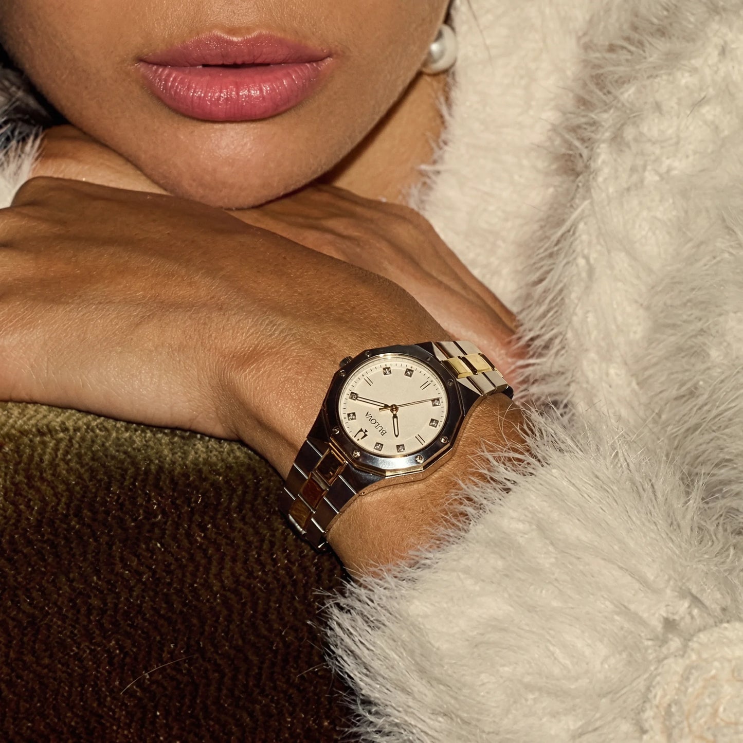 Two-tone silver and gold Bulova octagonal watch shown on a woman's wrist.