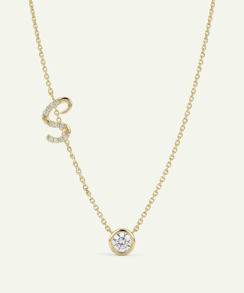 Silver necklace with a heart-shaped pendant on a white background